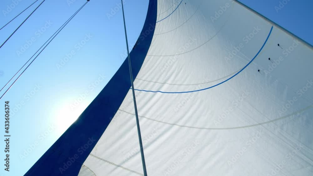 Nautical vessel. A sailboat mast and jib seen from below. 4k slow motion
