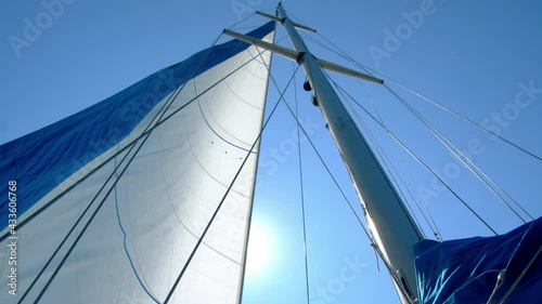 Nautical vessel. A sailboat mast and jib seen from below. 4k slow motion