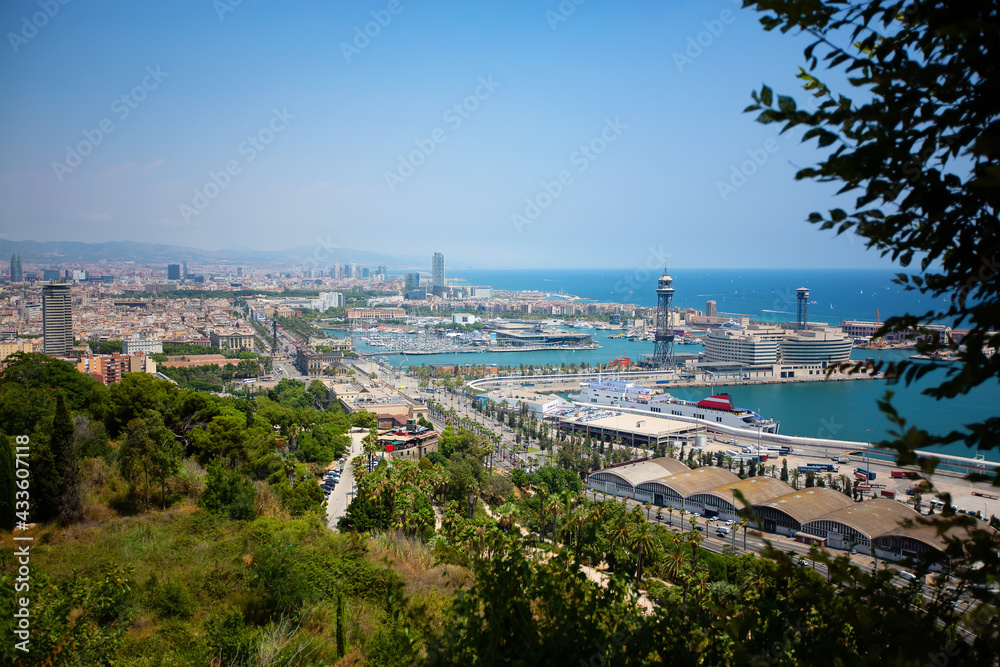 View from the height of the city of Barcelona in Spain. Sunny day. Urban landscape. View of the port and the sea.