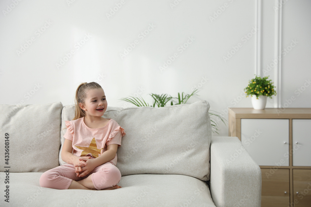 Little girl resting on comfortable sofa in living room Little girl resting on comfortable sofa in living room