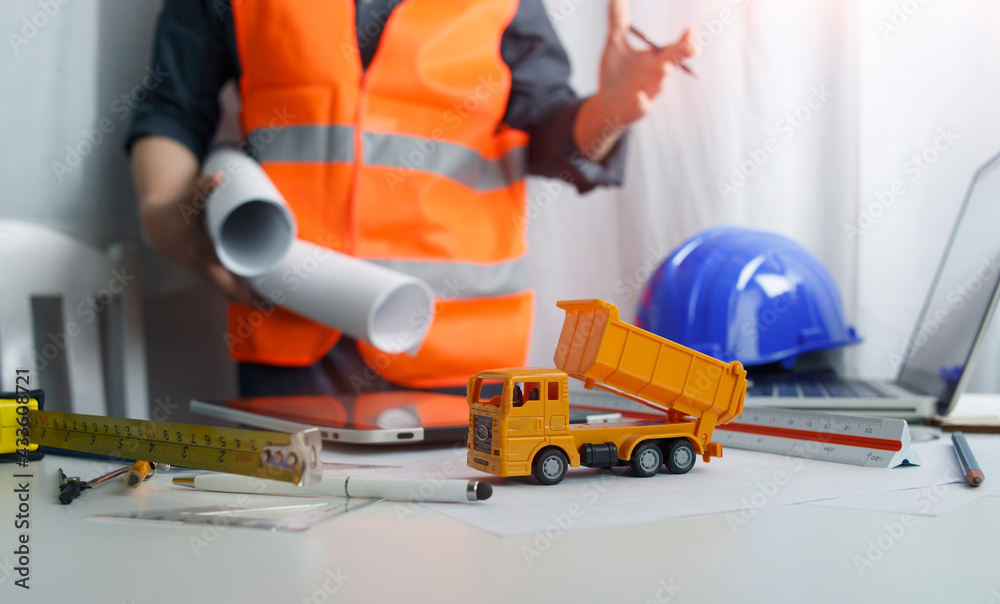 Fototapeta premium architect man working with blueprints,engineer inspection in workplace for architectural plan,sketching a construction project ,selective focus.