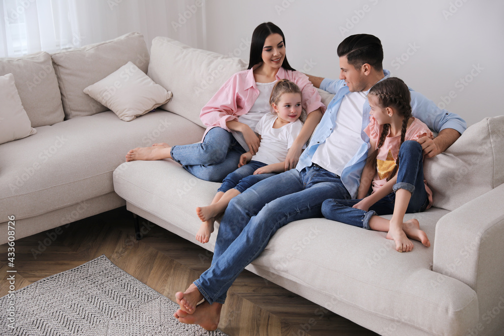Happy family resting on comfortable sofa in living room Happy family resting on comfortable sofa in living room
