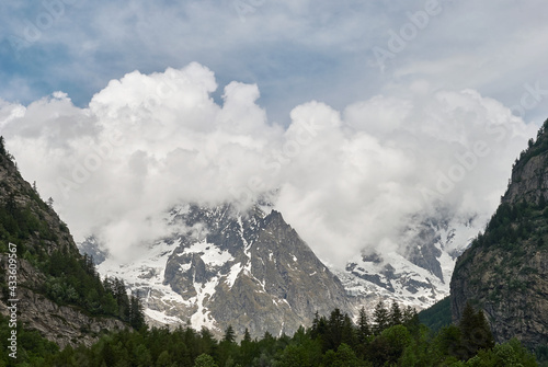 Panorama of a valley with peaks immersed in the clouds in Courmayeur, Val d'Aosta, Italy