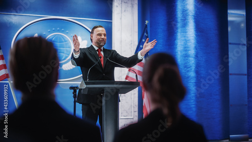 Charismatic Organization Representative Greeting Supporters at Conference in USA Government Building. Press Office Representative Delivering a Speech at a Summit. Minister Speaking to Congress.