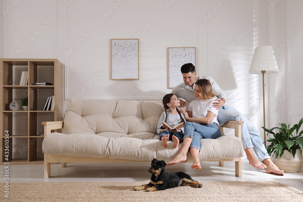 Happy family on sofa and puppy in living room Stock Photo | Adobe Stock