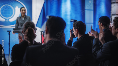 Pool of Photographers and Journalists Working at a Organization Press Conference with Female Representative Delivering a Speech at Press Conference in Government Building. Diplomat at a Summit.