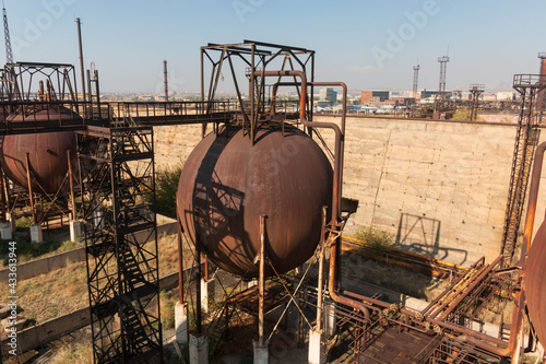 abandoned factory with rusty cisterns