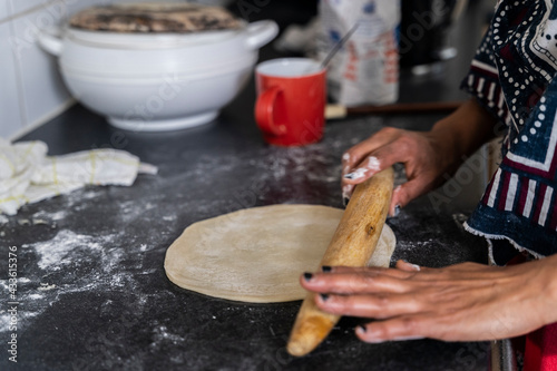 Black Muslim woman frying chapati