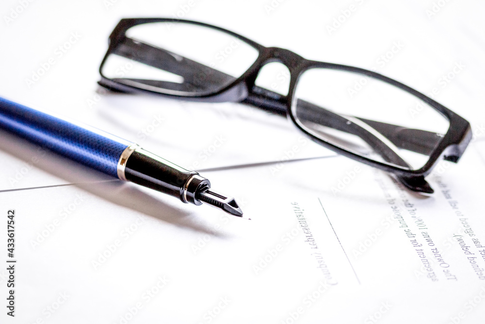 businessman office desk with contract for signig, glasses and pen businessman office desk with contract for signig, glasses and pen