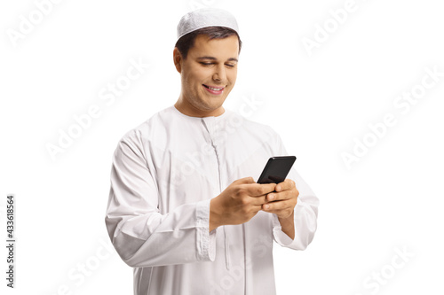 Young muslim man typing on a mobile phone