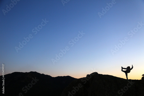 silhouettes of people in the mountain with sunrise sky background © fotoXS