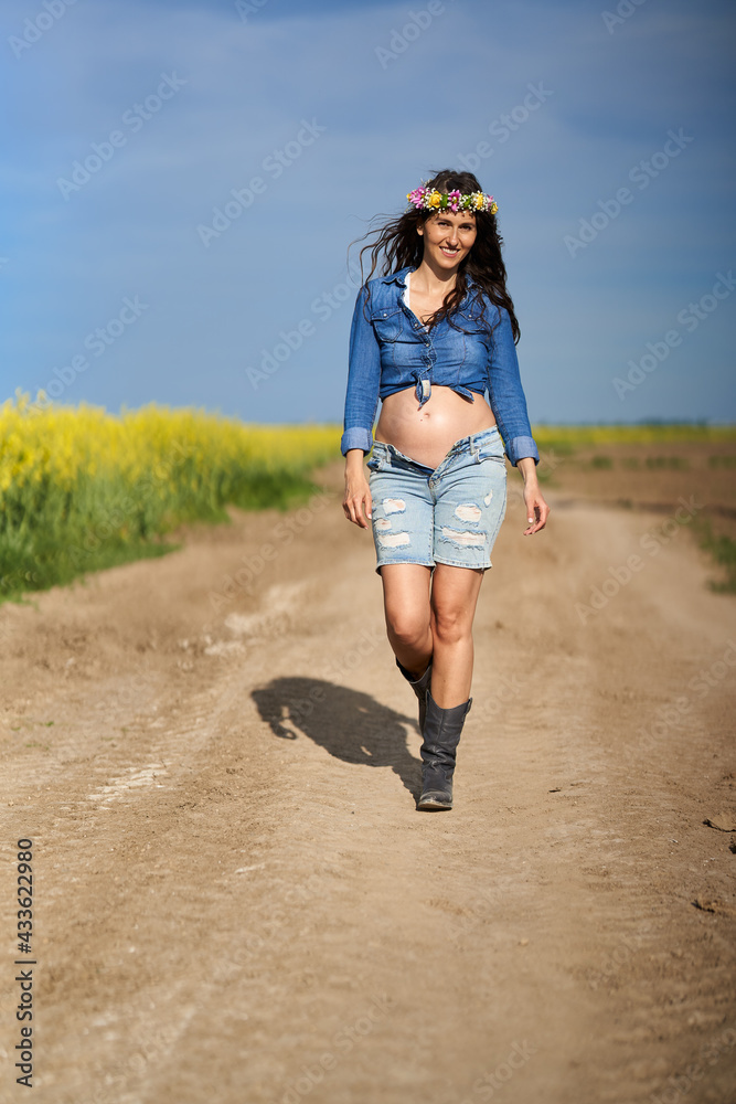 Pregnant woman on a road in the countryside Pregnant woman on a road in the countryside