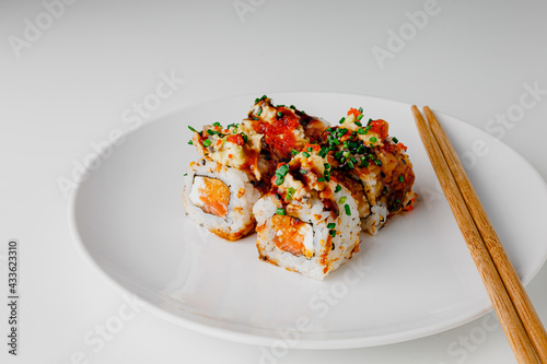 Japanese food: maki and nigiri sushi set. Sushi rolls with rice, fish salmon, smoked eel, avocado, cream cheese, soy Teriyaki sauce, sesame. Chopsticks, wasabi and Pickled Ginger.