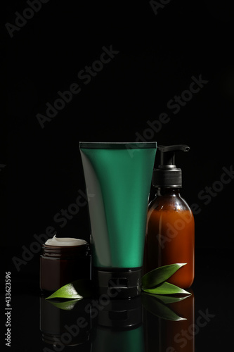 Facial cream and other men s cosmetic products on black background