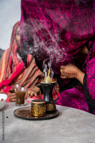 Black Muslim woman putting on incense 