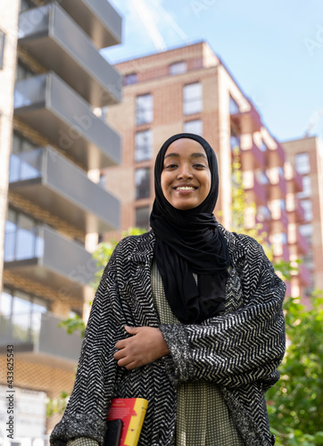 Fotografía Black Muslim woman standing in park with a book in hand