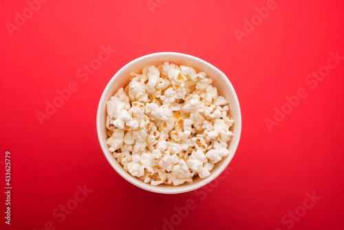 Heap of delicious popcorn isolated on background. Scattered popcorn texture background. Selective focus.