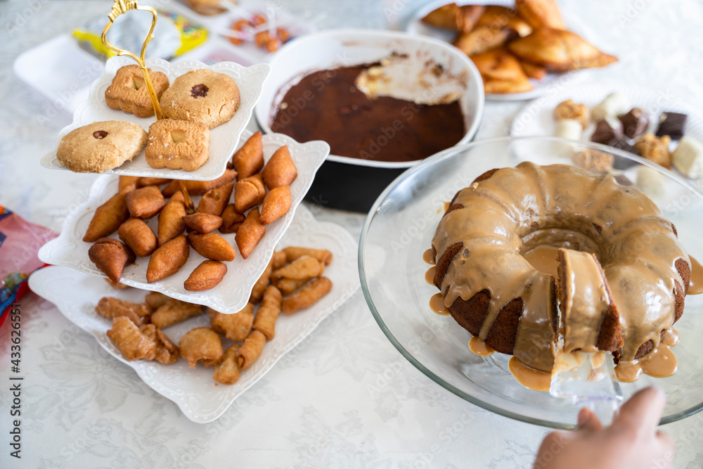 Eid dessert table with a selection of traditional snacks and cake Stock
