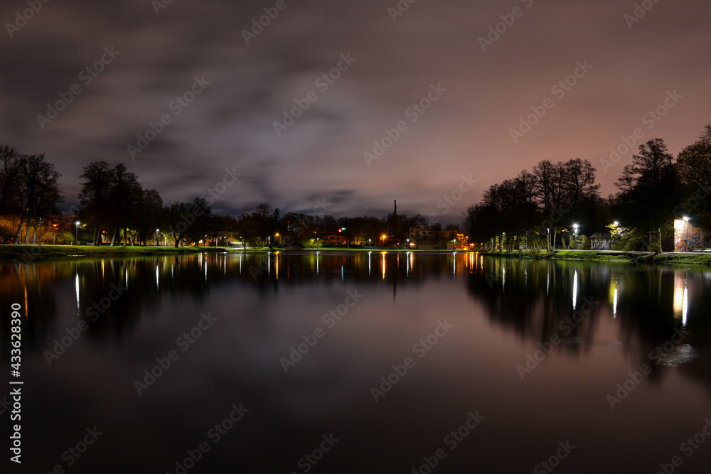 Night landscape. A lake with wonderfully calm water which reflects the lanterns of the park. Night landscape. A lake with wonderfully calm water which reflects the lanterns of the park.