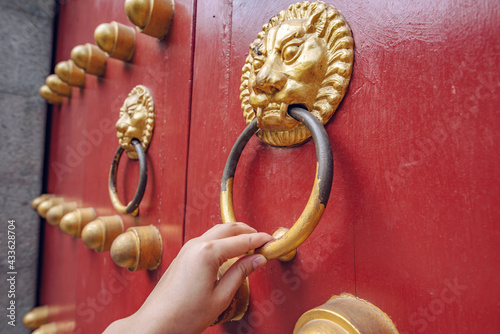 The first door knocker with animal heads on the Dahong Gate of an ancient Chinese building photo