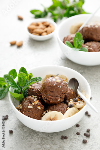 Chocolate and banana fruit ice cream with almond nuts served in bowls