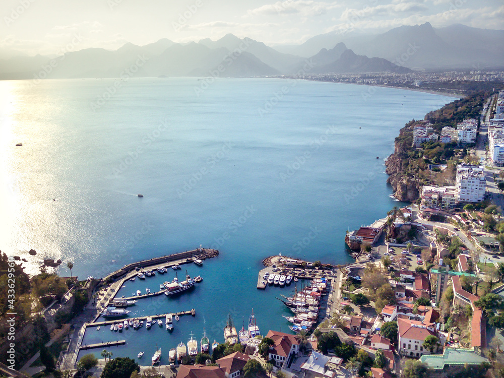 Aerial photograph of Antalya bay in Antalya city from high point of drone fly on sunny day in in Turkey. Amazing aerial cityscape view from birds fly altitude on beautiful town and sea full of yahts