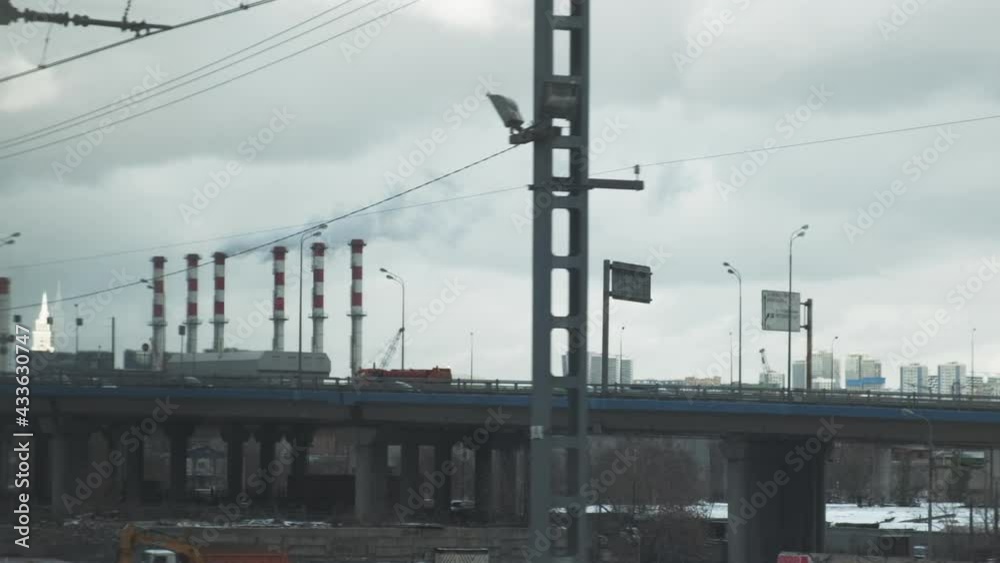 Industrial view from train window. Pipes of the thermal power plant and highways. Pollution of the environment. Industrial view from train window. Pipes of the thermal power plant and highways. Pollution of the environment.