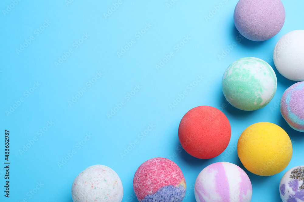Colorful bath bombs on light blue background, flat lay. Space for text Colorful bath bombs on light blue background, flat lay. Space for text