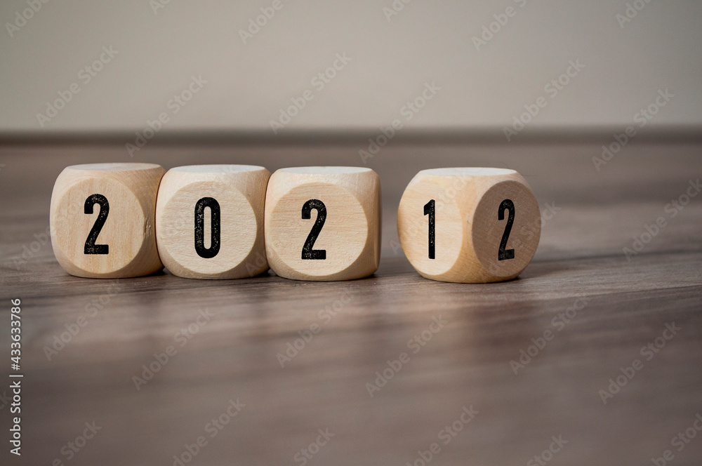 Cubes, dice or blocks with 2021 and 2022 on wooden background Cubes, dice or blocks with 2021 and 2022 on wooden background
