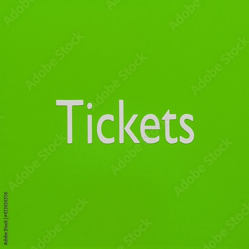 Green signboard with the word Tickets. Green button