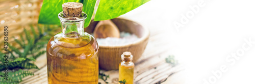 Concept of natural organic oil in cosmetology. Moisturizing skin care and aromatherapy. Gentle body treatment.  Wooden background, copy space, banner. Wellness body care, natural cosmetics background