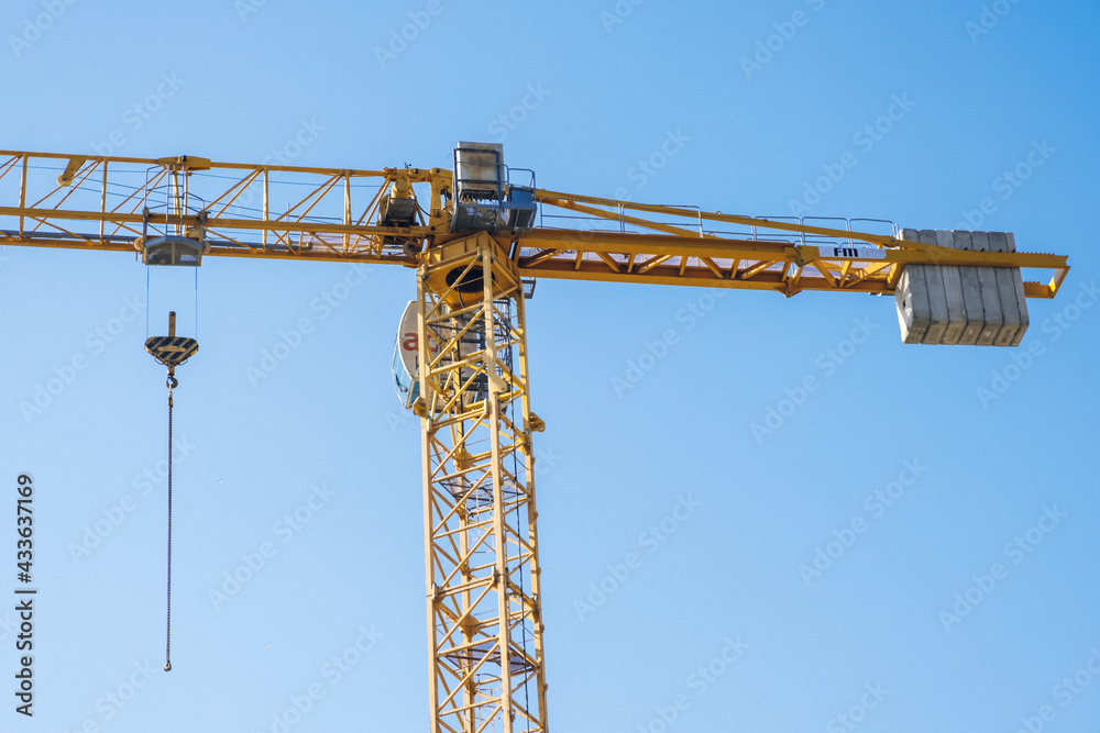 Atasehir, Istanbul - May 2021: Tower crane in skyscraper construction. Residence tower construction process. Tower crane in construction. Atasehir, Istanbul - May 2021: Tower crane in skyscraper construction. Residence tower construction process. Tower crane in construction.