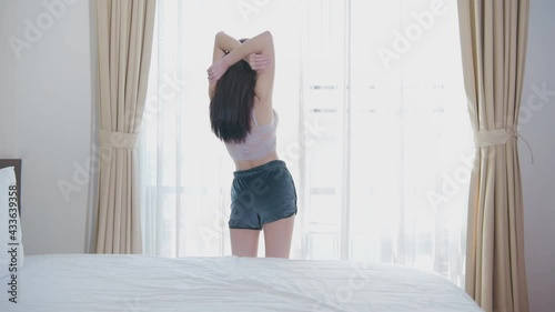 Holiday concept of 4k Resolution. Asian girls looking at the view by the window in the morning.