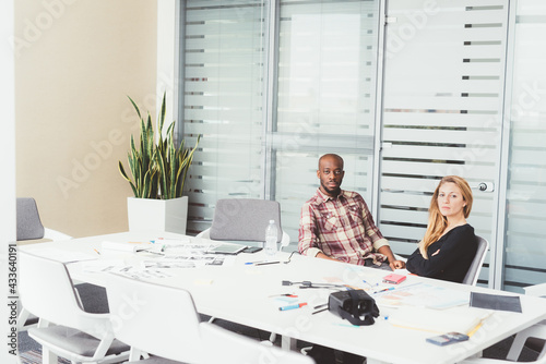 Two millennials multiethnic business people working photo