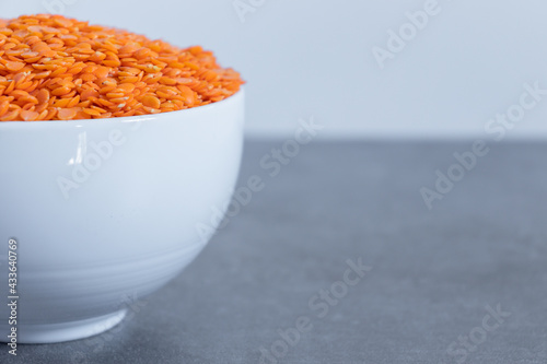 Dhal beans in a white shiny ceramic bowl close up.