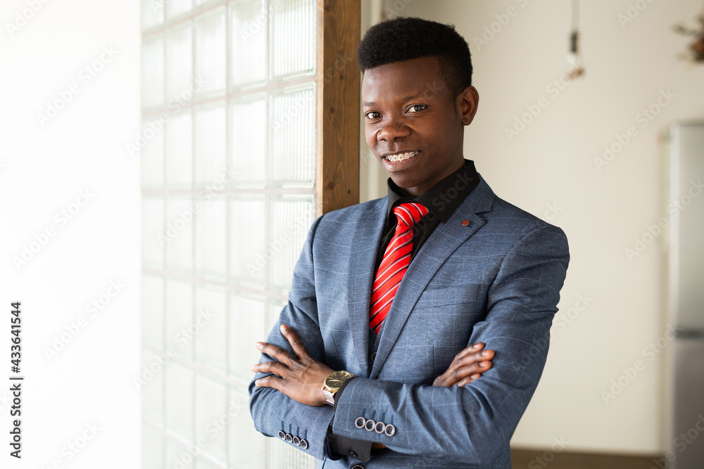 handsome young african man in suit at office handsome young african man in suit at office