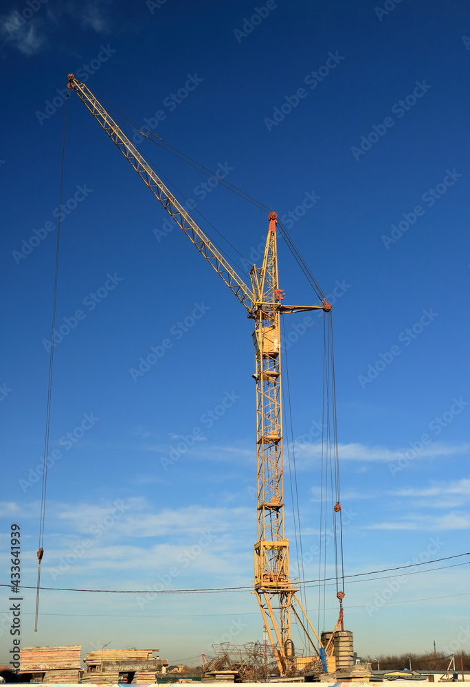 Tower cranes are working on the construction of a new house. Lifting crane.