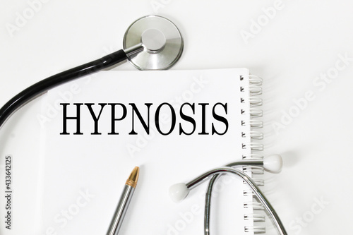notepad with text HYPNOSIS on the medical table, stethoscope, pen. medical concept