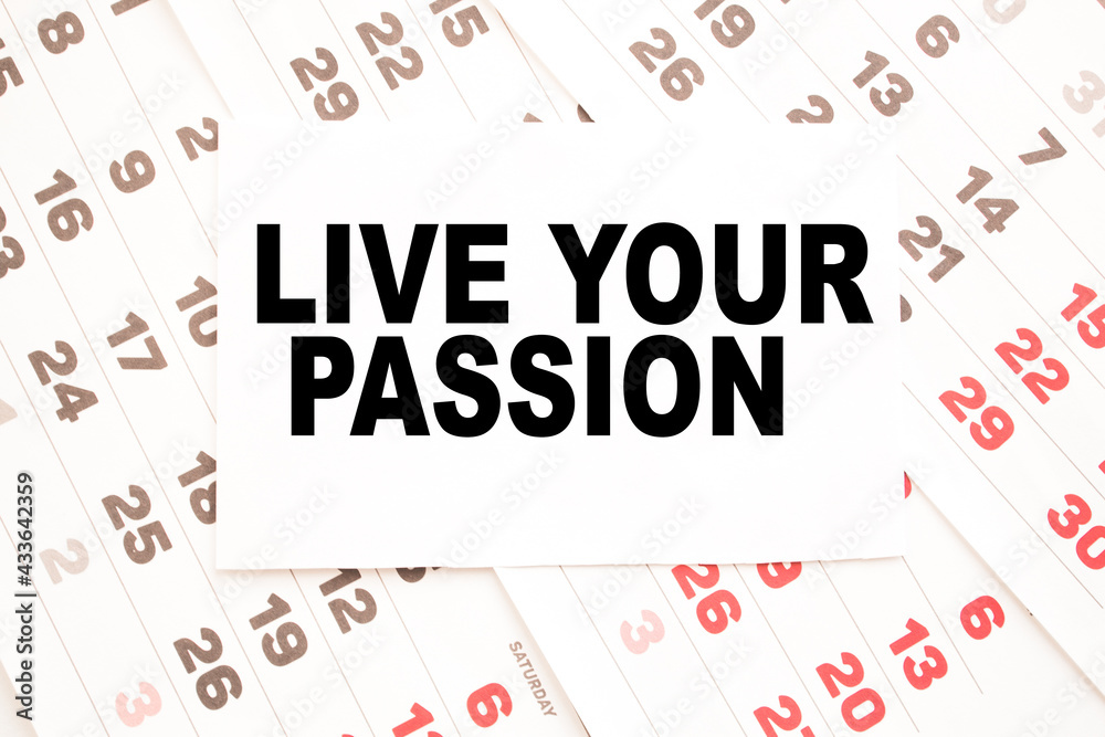 Notepad with text LIVE YOUR PASSION on the office desk with stationery. A blank notepad for entering a copy or text. business Notepad with text LIVE YOUR PASSION on the office desk with stationery. A blank notepad for entering a copy or text. business