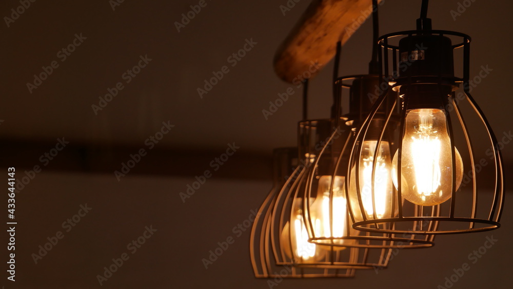 A row of glowing ceiling light bulbs