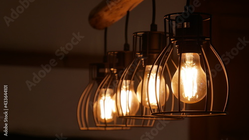 A row of glowing ceiling light bulbs