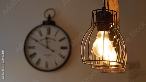 Row of ceiling lights with a clock in the background