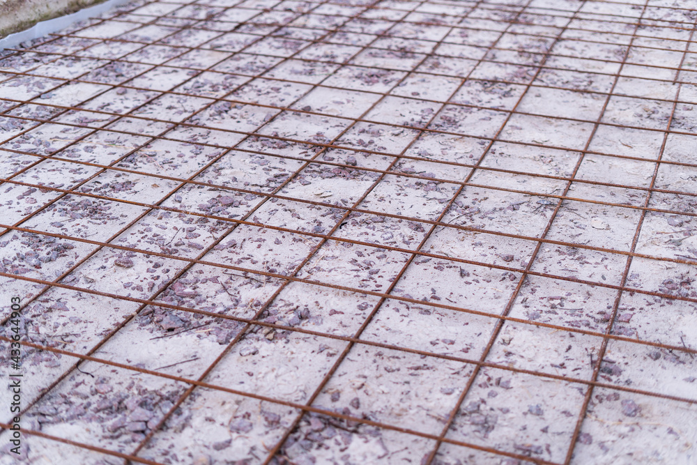 Iron reinforcement lying on the floor prepared for bonding and reinforcement before pouring concrete Iron reinforcement lying on the floor prepared for bonding and reinforcement before pouring concrete