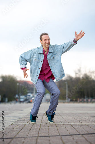 young man in 1980s style dancing in the street © wernerimages