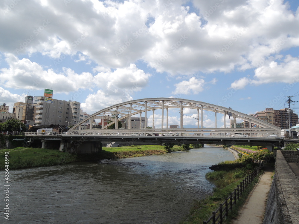 Fototapeta premium bridge over the river with blue sky and white cloud in the background