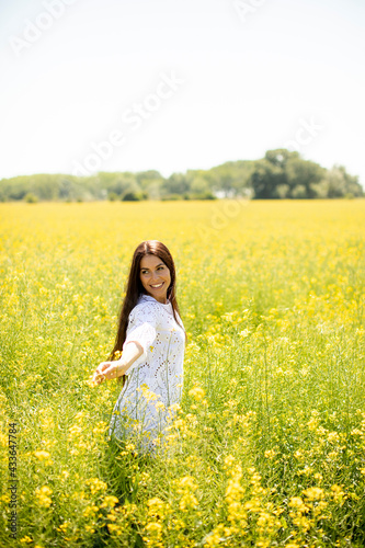 Young woman in the rapeseed field