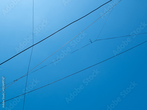 Electric Cables with a Clear Blue Sky Background