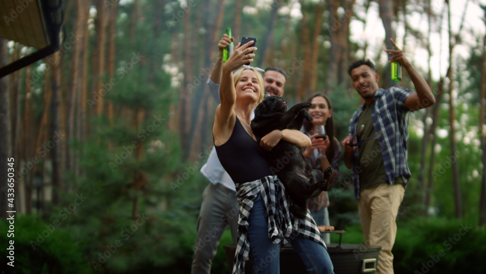 Cheerful fellows making group photo outside. Friends taking selfie on backyard