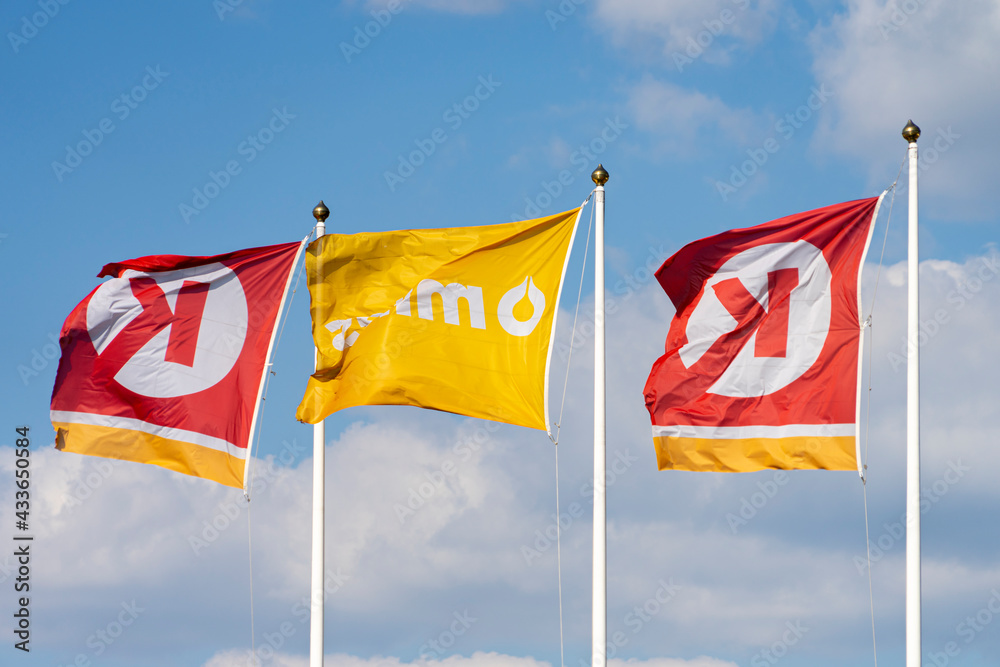 Flags With Circle K Logo Near Gas Station Over Blue Sky Circle K Is flags-with-circle-k-logo-near-gas-station-over-blue-sky-circle-k-is