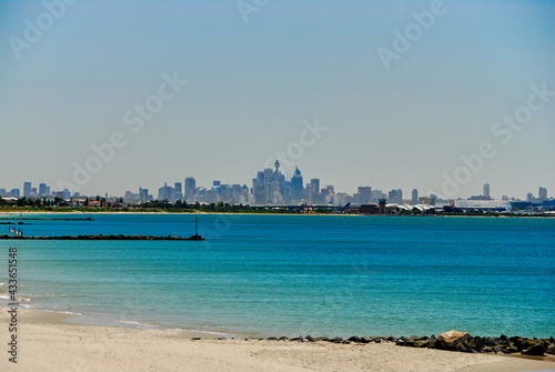 Southern view of the Sydney skyline on a hazy summer day, seen from the shoreline of Botany Bay in New South Wales, Australia.